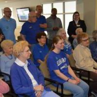 Volunteers and seniors listen to the instructions of the game.